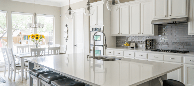 A gray kitchen with white cabinets