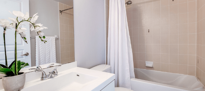 A white and beige bathroom that is not getting hot water 