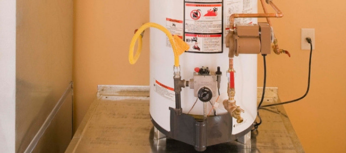 A water heater located in an orange closet with a pilot light that won't stay lit