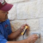 a commercial electrician testing a business’ outlets