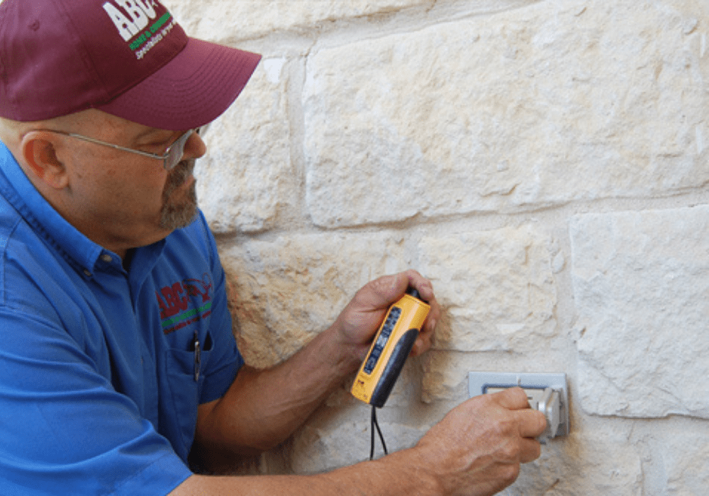 a commercial electrician testing a business’ outlets