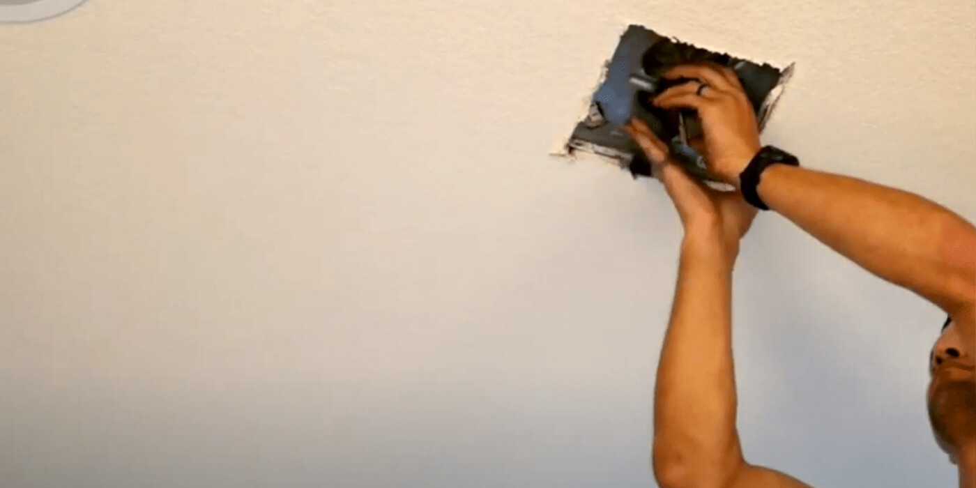 a licensed electrician fixing a homeowner’s electrical outlet