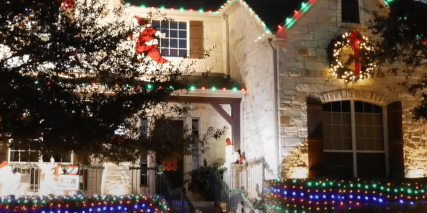 ABC professionals hanging Christmas decorations on a home