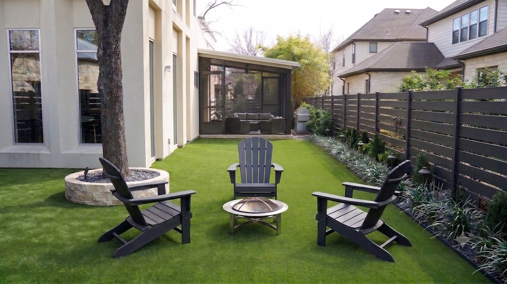 an artificial turf patio, chairs, and fire pit