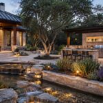 a xeriscaped back yard with an outdoor kitchen