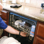 a specialist repairing a broken dishwasher