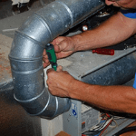 an ABC specialist repairing a homeowner’s heating system