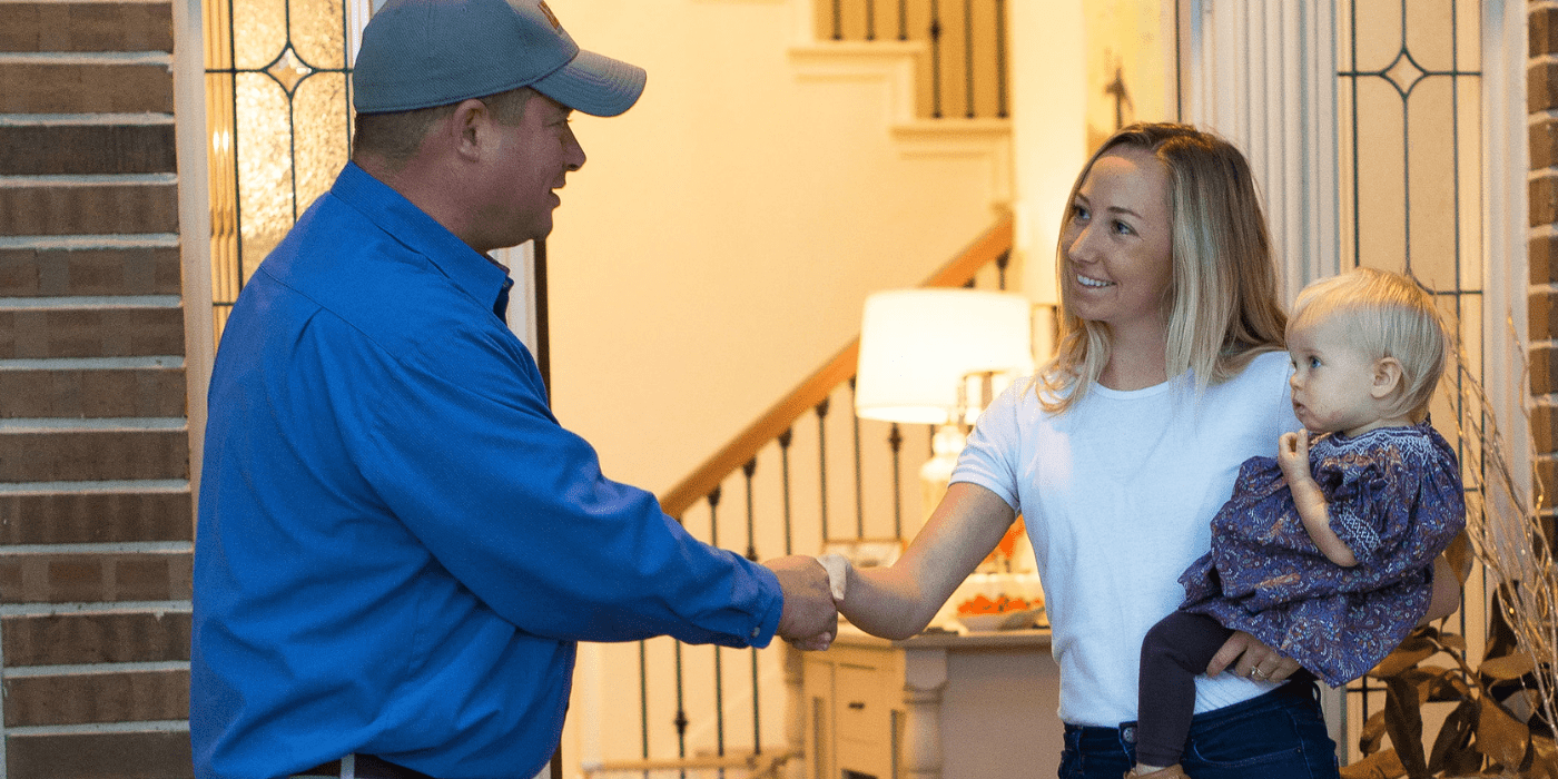 a licensed appliance repair specialist greeting a homeowner who is in need of washer repair