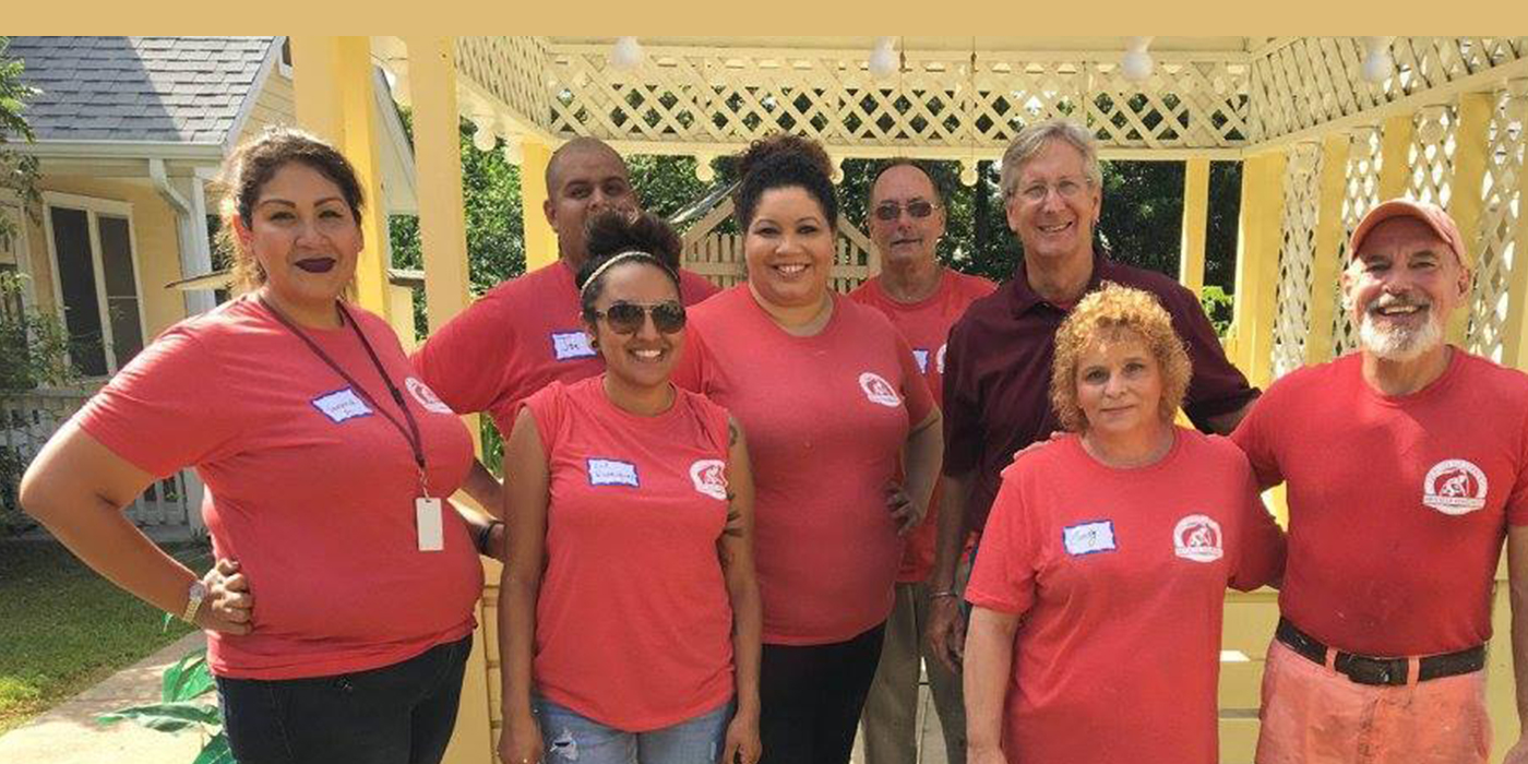 A group of smiling ABC employees at a Habitat for Humanity event