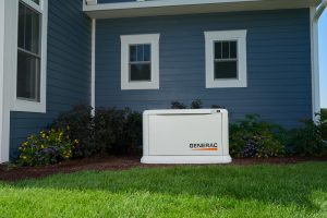 Generac brand generator outside of a blue house