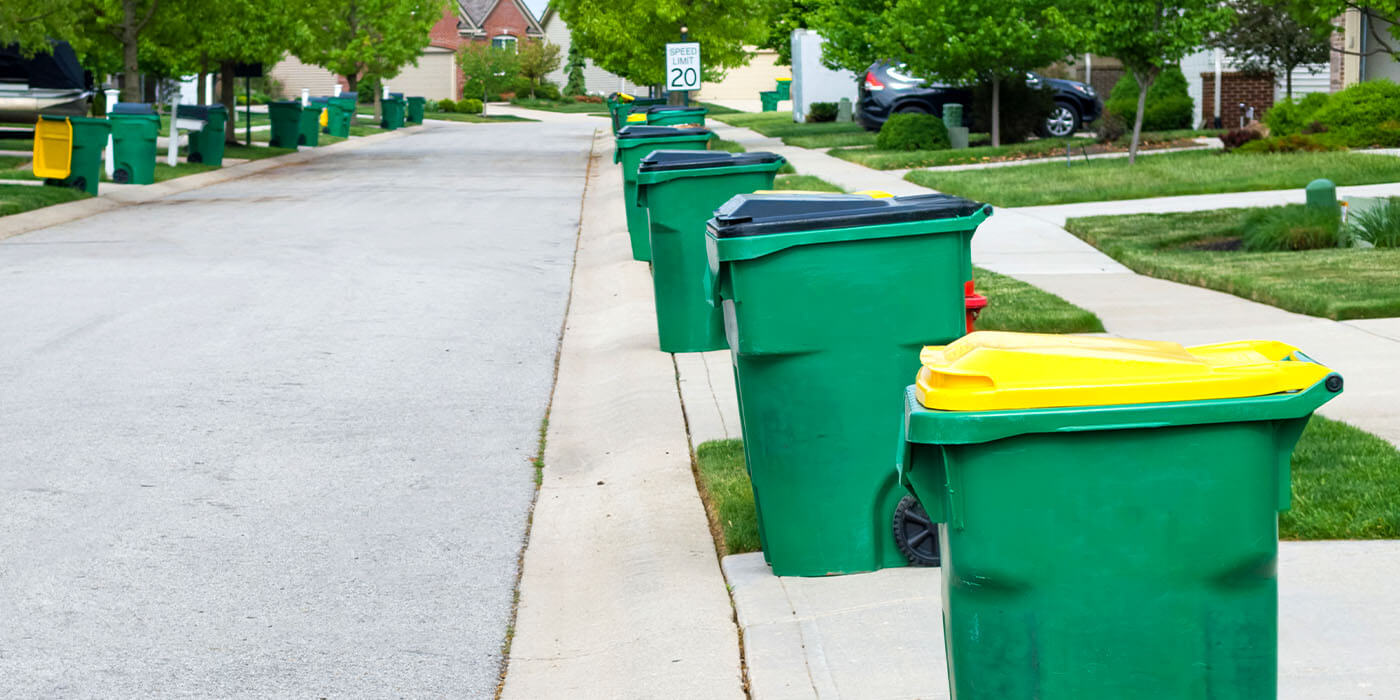 row of trash cans on a residential street in Austin