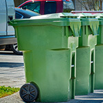 A row of trash can bins on the street in Austin