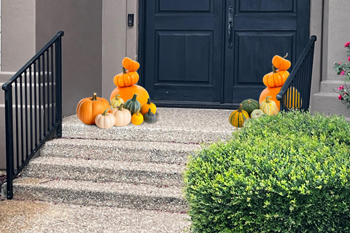 front pront porch decorated with over 20sd pumpkins