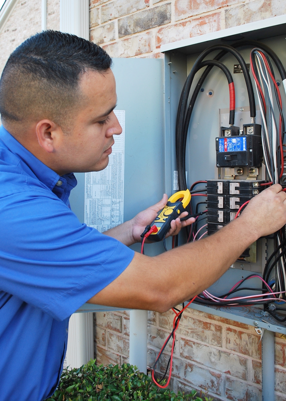An ABC electrician working on an electrical panel