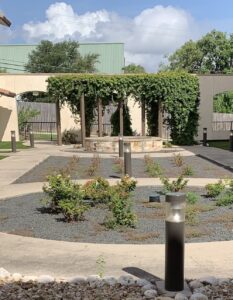 a courtyard with gravel and plants