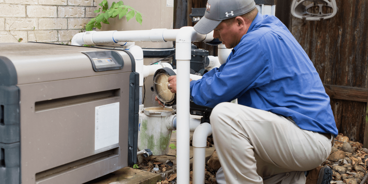 a certified pool professional cleaning a homeowner’s pool