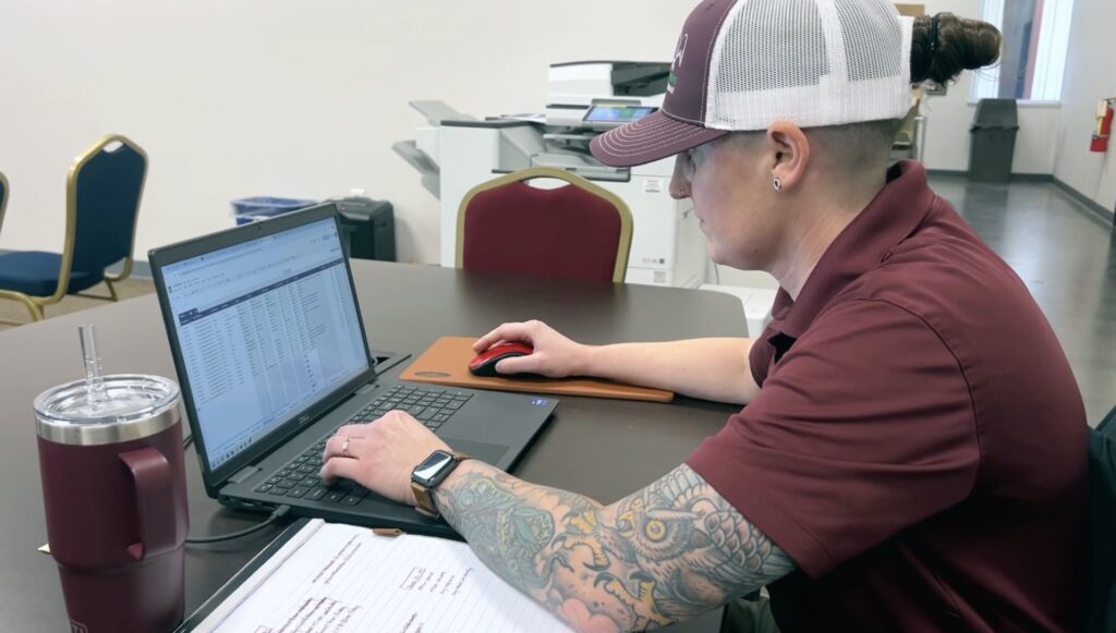 an ABC employee working on a laptop at a desk