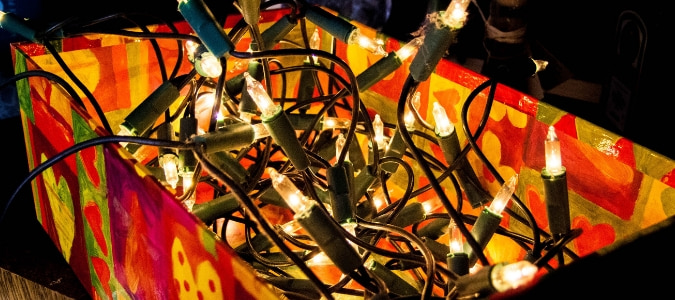 Tangled holiday lights in a box which has led a homeowner to wonder the best way to store christmas lights