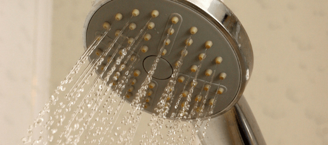a shower that has been turned on with hot water coming from a tankless water heater