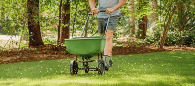 a homeowner fertilizing their lawn