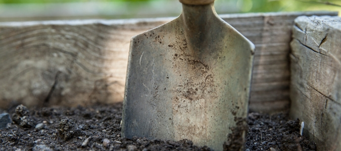 a shovel in a pile of compost