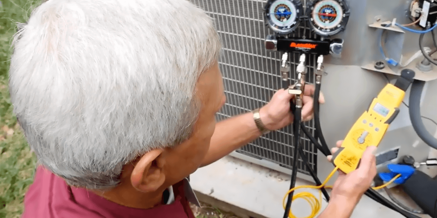 heating and cooling specialists maintaining a homeowner’s air conditioning unit