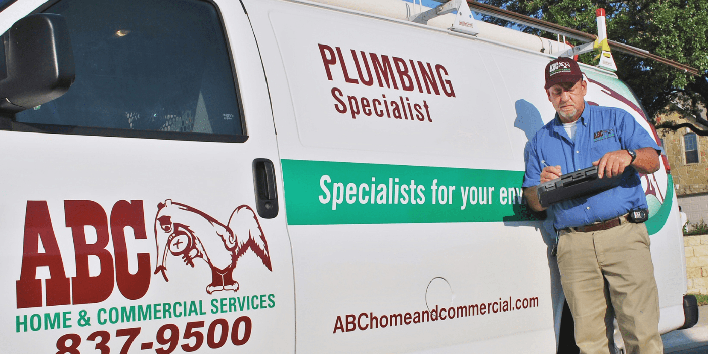 an ABC plumbing specialist writing water and gas line recommendation for customer