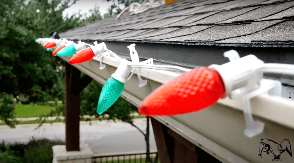 Holiday lights installed on the gutters of a residential house