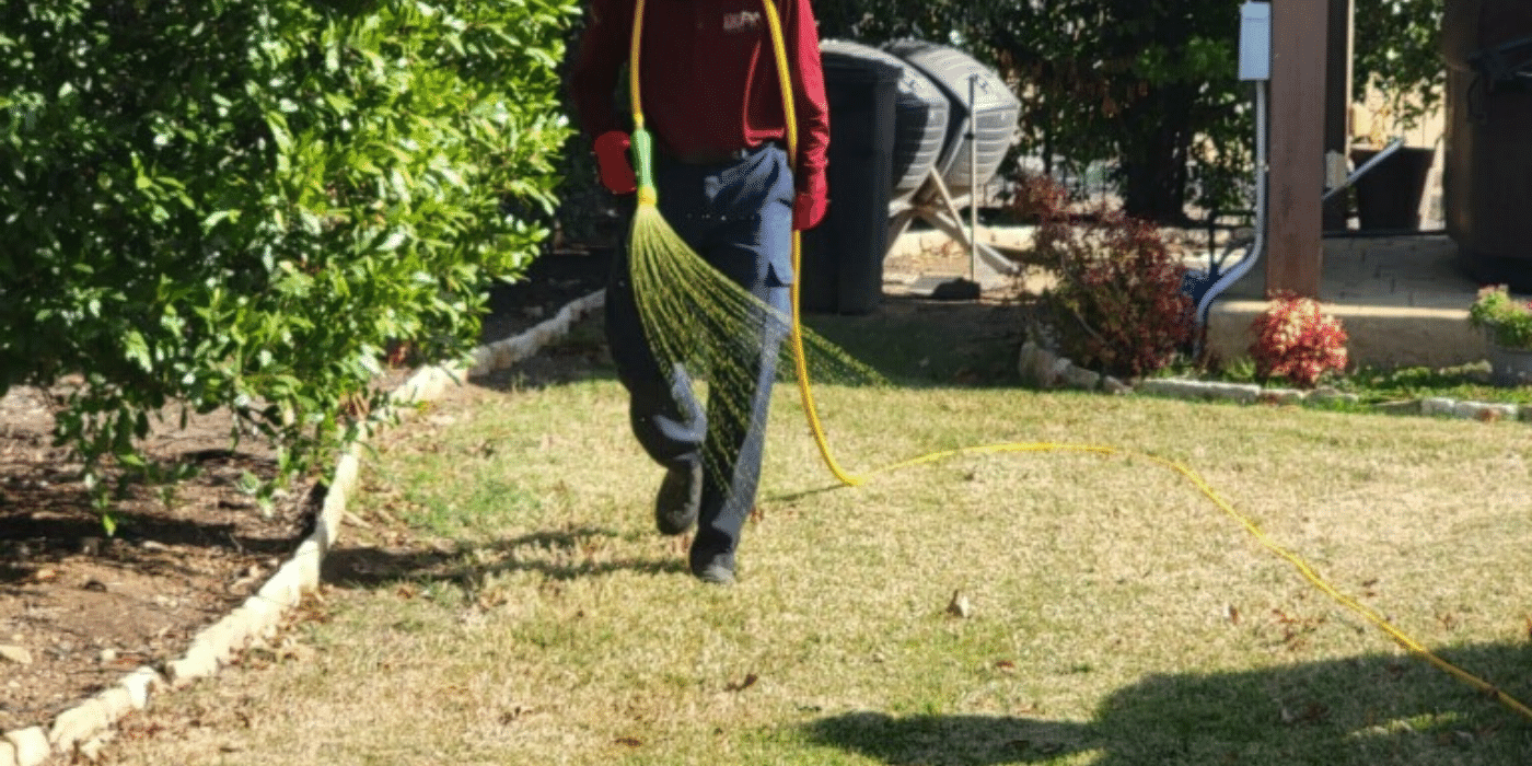 An ABC team member spreading fertilizer