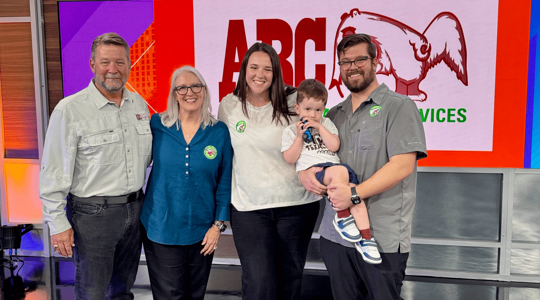 The Jenkins Family in front of a large screen with an ABC logo at a local TV studio.