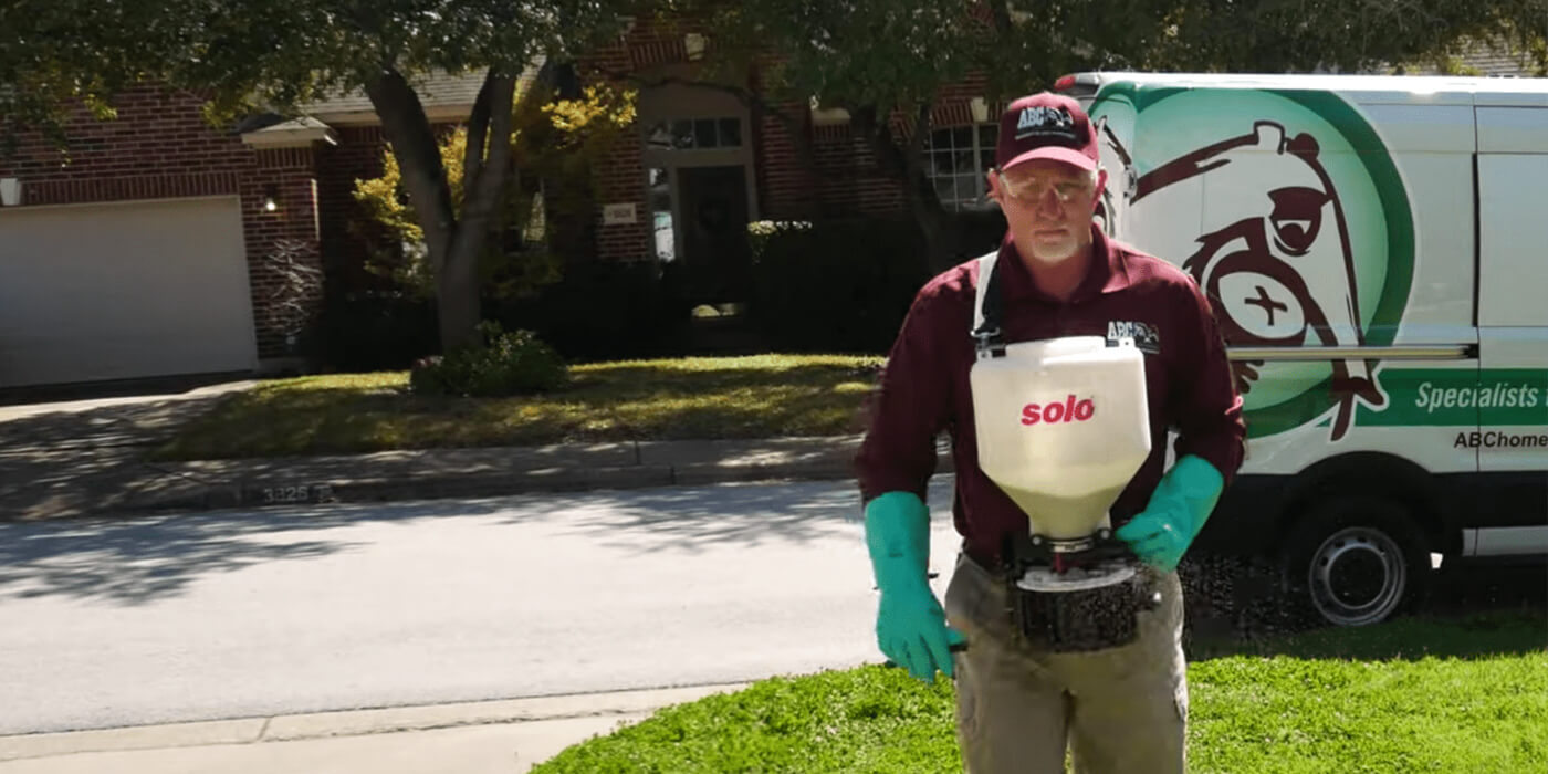 an ABC lawn care specialist providing lawn maintenance services