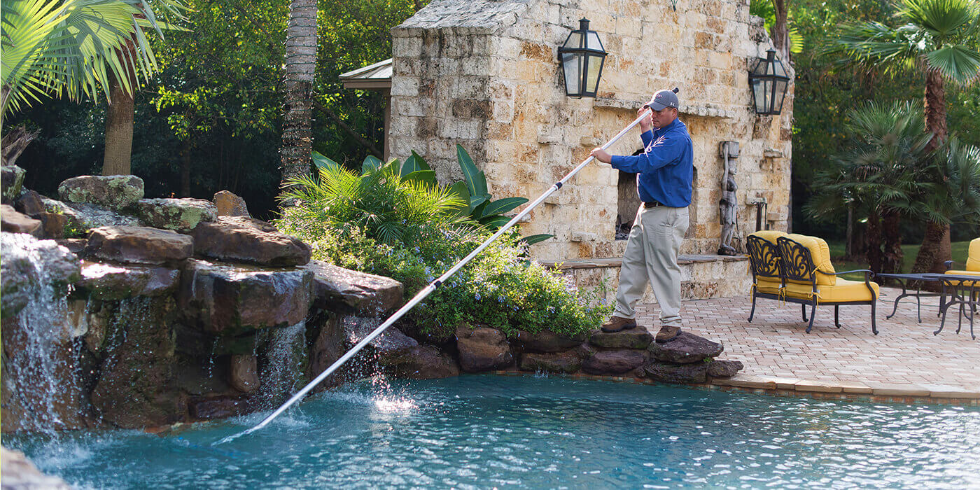 an ABC specialist cleaning a pool