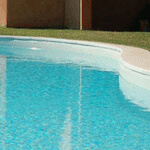 a newly replastered indoor pool by ABC specialists filled with clear, blue water