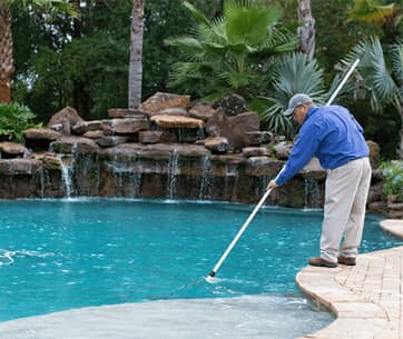ABC pool service specialists working on a Houston swimming pool