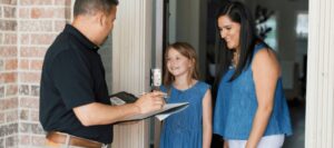 An ABC specialist discussing a termite inspection with a family
