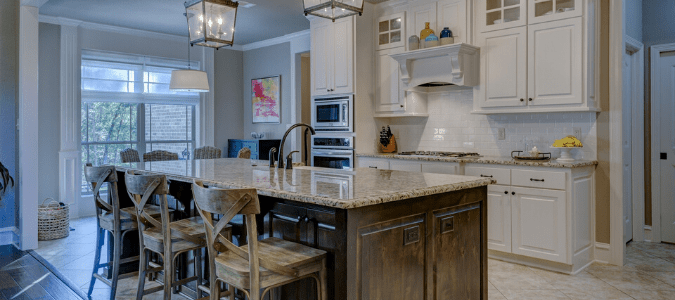 A white kitchen with a wooden island