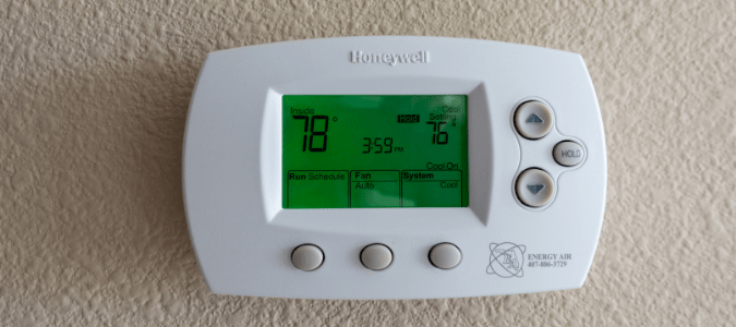 Honeywell thermostat flashing "cool on" on a wall