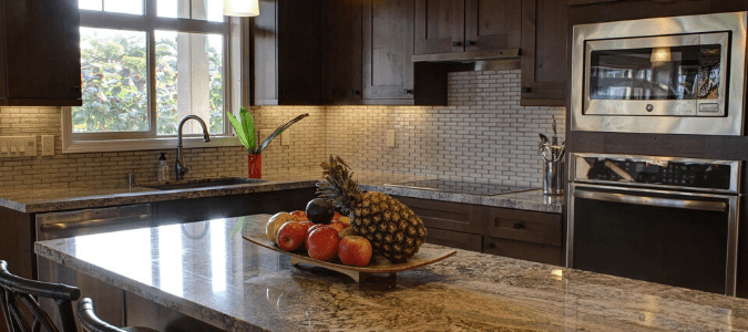 A brown kitchen with a granite countertop