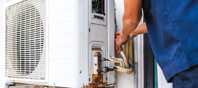 a professional working on an AC unit