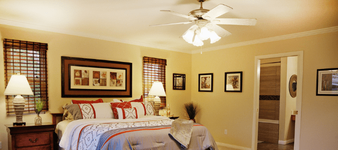 a bedroom with a ceiling fan that stopped working