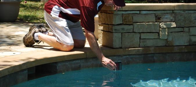 an ABC specialist testing pH levels of a pool
