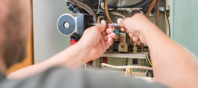 a pro repairing a furnace