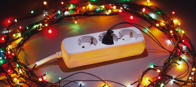 Christmas lights around electrical outlet