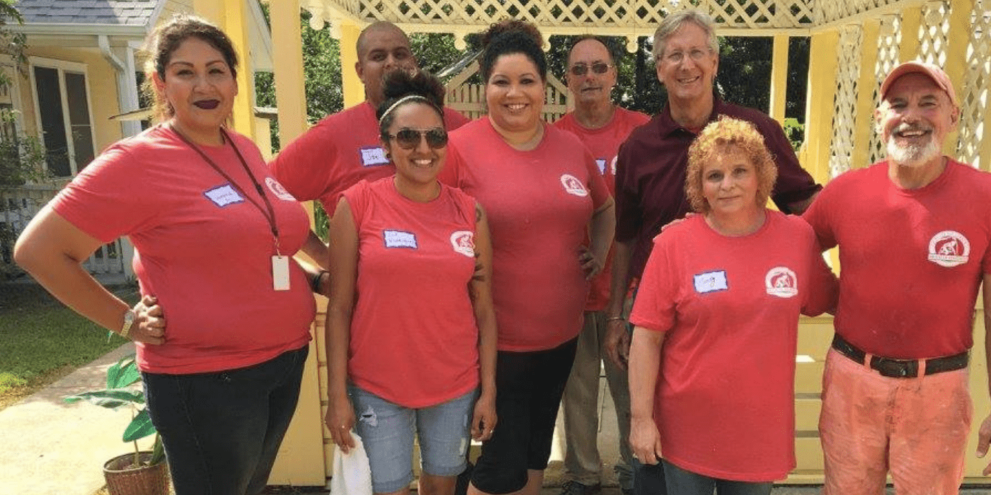 A group of smiling ABC employees at a Habitat for Humanity event