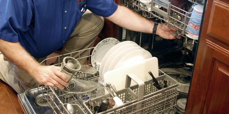 an appliance repair pro working on a dishwasher