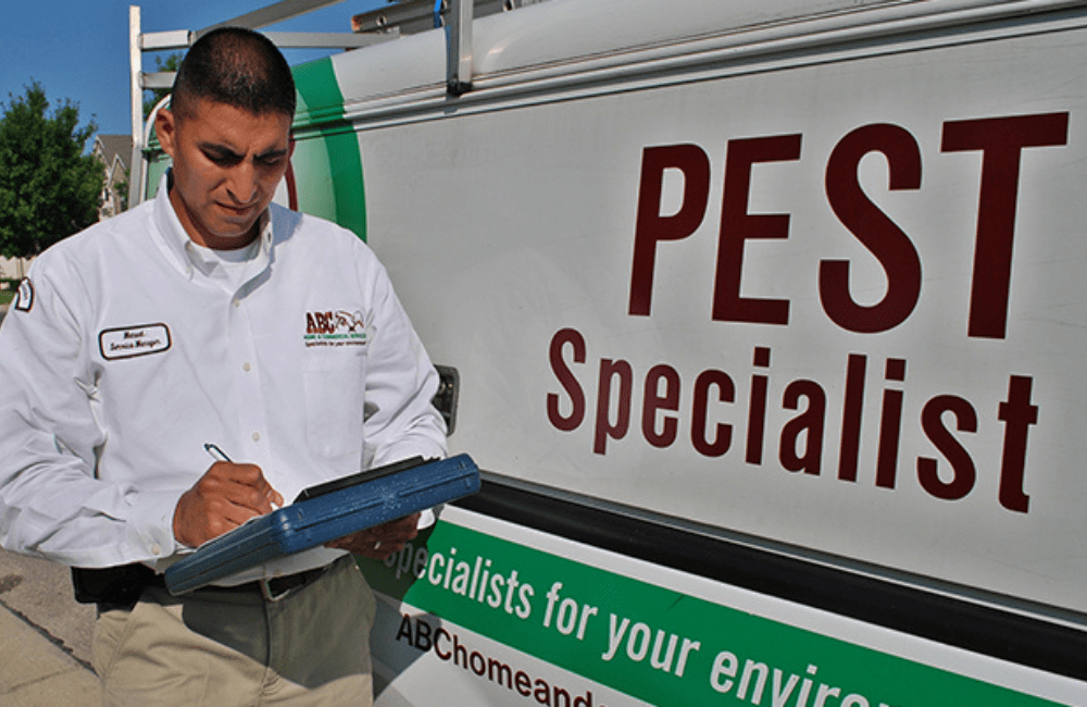 an ABC pest control specialist creating a custom treatment plan for a customer