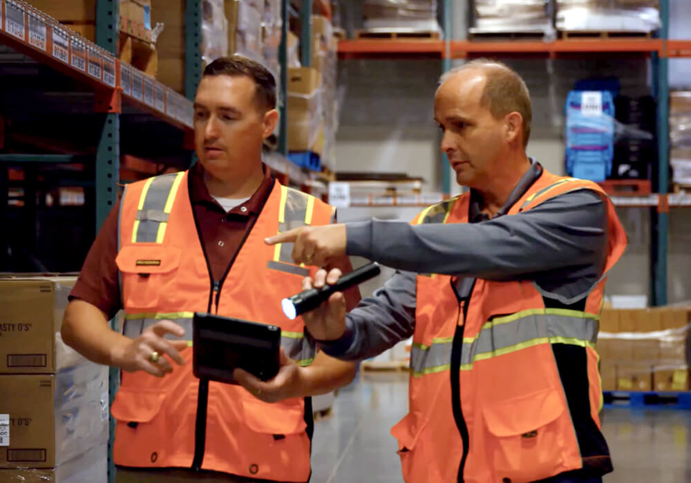 two ABC employees working in a warehouse