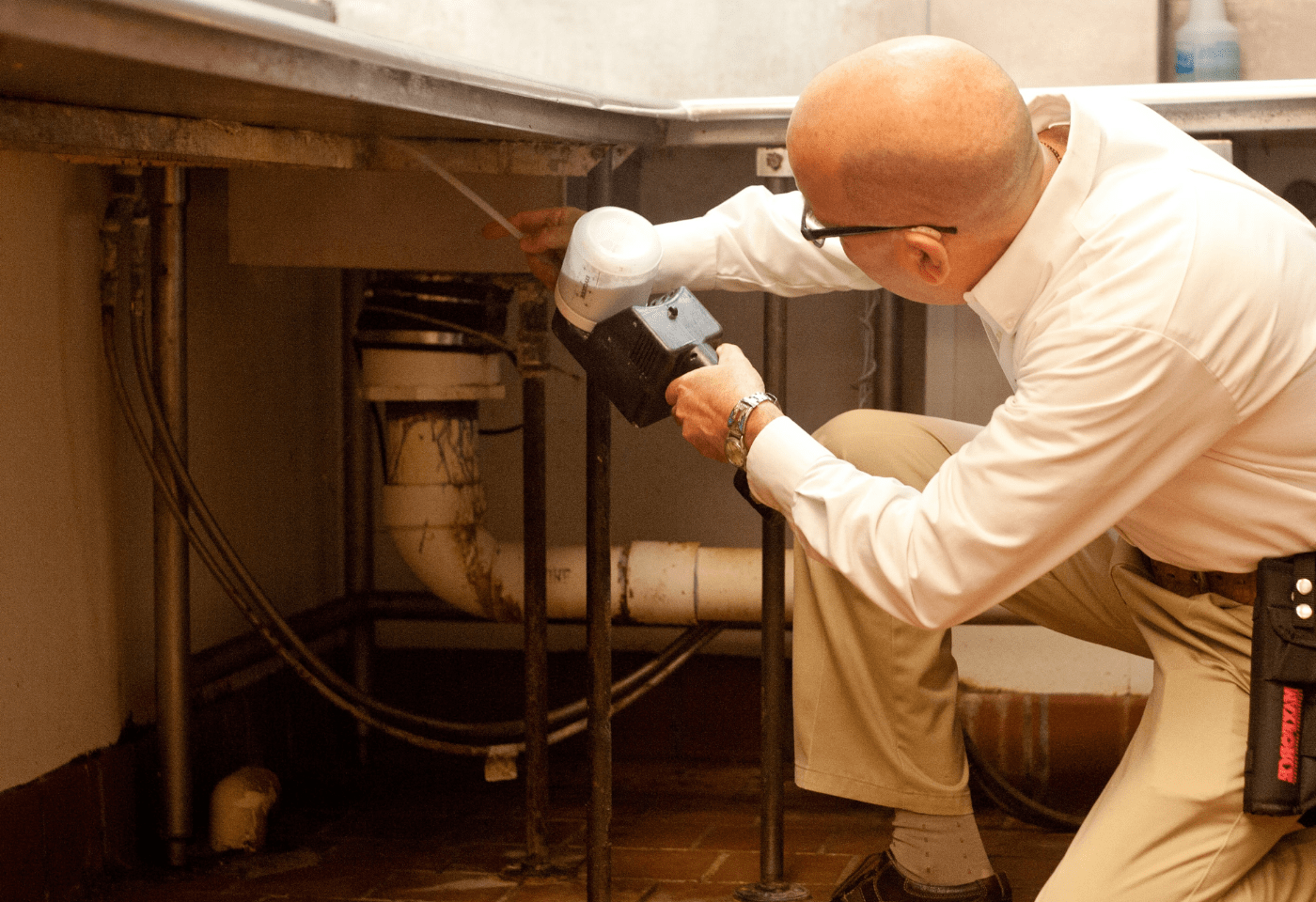 An ABC commercial pest control specialist performing an inspection at a restaurant