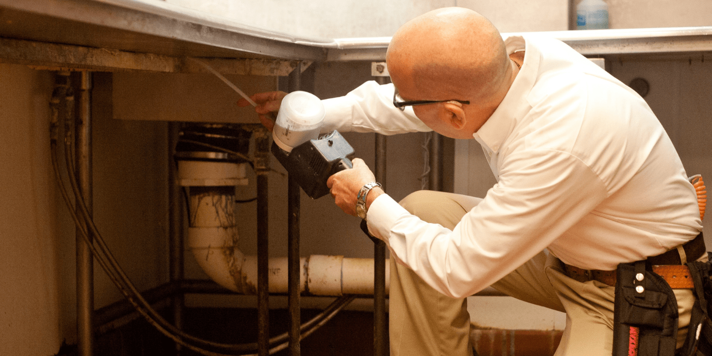 a pest control specialist performing an inspection at a hotel