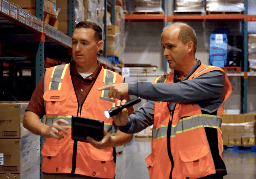 commercial pest control specialists performing an inspection at a food distribution facility